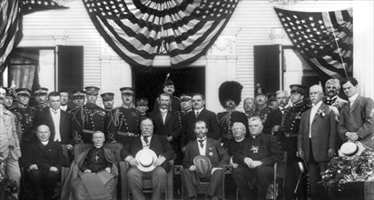 U.S. President William Howard Taft (seated center), Charles Evans Hughes (seated right), Cardinal James Gibbons (seated left), and other unidentified men, Group Portrait during visit to Catholic Summe...