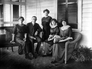New jersey Governor Woodrow Wilson, Full-Length Portrait Seated on Porch Swing of his Summer Home, alongside first wife Ellen Axson Wilson and Three Daughters, L-R: Jessie, Margaret and Eleanor, Sea G...