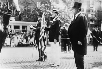 U.S. President Woodrow Wilson, holding U.S. flag, in parade, on Preparedness Day, Washington, D.C., USA, June 14, 1916