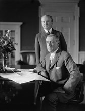 U.S. President Woodrow Wilson sitting at Desk in White House Oval Office with his Private Secretary Joseph Patrick Tumulty Standing nearby during Wilson's First Term in Office, Washington, D.C., USA, ...