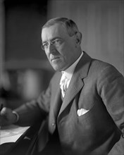 Woodrow Wilson (1856-1924) 28th President of the United States 1913-1921, Half-Length Portrait seated at desk in White House Oval Office, Washington, D.C., USA, Photograph by  Harris & Ewing, 1913-191...
