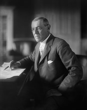 Woodrow Wilson (1856-1924) 28th President of the United States 1913-1921, Half-Length Portrait seated at desk in White House Oval Office, Washington, D.C., USA, Photograph by  Harris & Ewing, 1913-191...