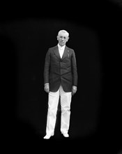 Woodrow Wilson (1856-1924) 28th President of the United States 1913-1921, Full-Length Standing Portrait against Black Background, Photograph by  Harris & Ewing, 1917-1921