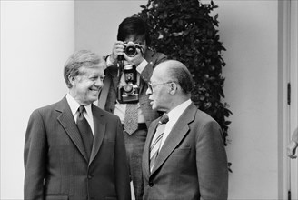 U.S. President Jimmy Carter and Israeli Prime Minister Menachem Begin talk at the White House as photographer adjusts his camera in background, Washington, D.C., USA, photographer Thomas J. O'Halloran...