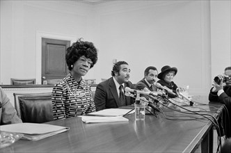Democratic U.S. Congresswoman Shirley Chisholm Announcing her Candidacy for U.S. Presidential Nomination with Representatives Parren Mitchell, Charles Rangel, and Bella Abzug seated at Table with Micr...