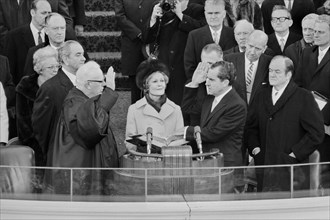 Chief Justice Earl Warren administering the oath of office to Richard M. Nixon on the east portico of the U.S. Capitol, Washington DC, USA, photograph by Thomas J. O'Halloran, January 20, 1969