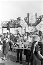 African American and white supporters of the Mississippi Freedom Democratic Party holding signs in front of the convention hall at the 1964 Democratic National Convention, Atlantic City, New Jersey, U...