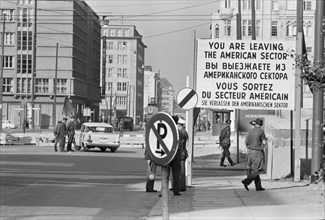 Checkpoint in West Berlin, West Germany with sign "You are leaving the American Sector" in four languages, photograph by Thomas J. O'Halloran, October 1961