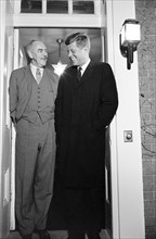 U.S. President-Elect John F. Kennedy and former U. S. Secretary of State Dean Acheson, standing in the doorway of Acheson's home at 2805 P Street, N.W., Washington, D.C., photograph by Marion S. Triko...