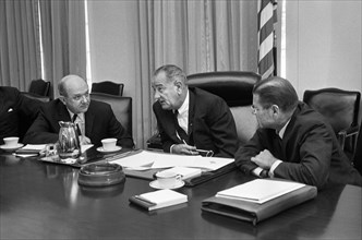 U.S. Secretary of Defense Robert McNamara (right), U.S. President Lyndon Johnson and U.S. Secretary of State Dean Rusk, seated at a table after McNamara's return from South Vietnam, Washington, D.C., ...