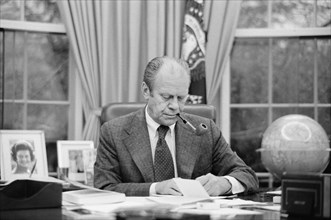 U.S. President Gerald Ford working at his Desk, smoking a Pipe, White House, Washington, D.C., USA, photograph by Marion S. Trikosko, February 6, 1975