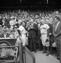 U.S. President Dwight Eisenhower getting ready to Toss out First Ball at Opening Day Baseball Game between Washington Senators and New York Yankees, Yankees Manager Casey Stengel to right, Senators Ma...