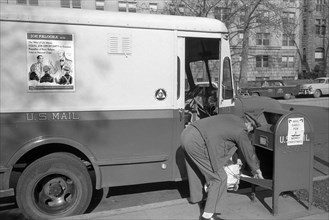 Mailman picking up Mail from Mailbox, Job Opportunity Poster on Side of Mail Truck, Washington, D.C., USA, photograph by Thomas J. O'Halloran, February 1957