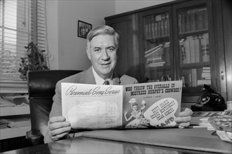 Massachusetts Congressman Thomas P. "Tip" O'Neill, Half-Length Portrait sitting at Office Desk and holding Sheet Music, Washington, D.C., USA, photograph by Thomas J. O'Halloran, August 1957