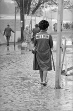 Rear View of African-American Woman wearing a "I Have a Dream" Jacket Walking through Mud in Shantytown known as "Resurrection City", Washington, D.C., USA, photographer Thomas J. O'Halloran, Marion S...
