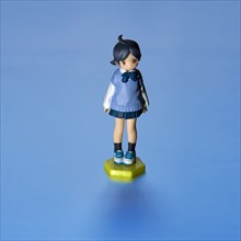 Young Girl Figurine, Blue against Blue Background
