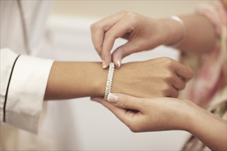 Putting Bracelet on Bride's Wrist