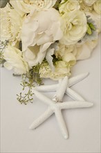 Engagement Ring on Starfish Decoration and Flowers