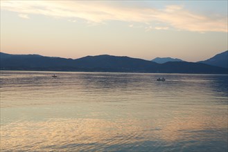 Fishermen at Dusk with Mountainous Landscape in Background, Patras, Greece