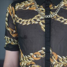 Man's Torso with Black See-Through Shirt and Chain