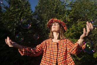 Mid-Adult Woman in Vintage Outfit with Bubbles