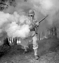 Sergeant George Camblair learning how to use a gas mask in a practice smokescreen