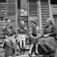 Women talking in Front of Home