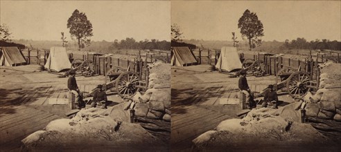 Two Soldiers sitting amid Confederate Weapons and Fortifications