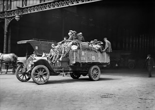 American Red Cross Workers taking a Camion load of Refugees with their Baggage from the Gare de l'Est to another Station