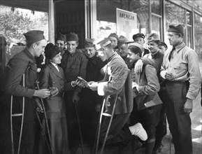American Red Cross Worker distributing Cigarettes to wounded American Soldiers at Rest Station