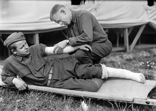 American Soldiers at American Military Hospital No. 5 demonstrating the use of Bandages that were received in Front Parcels made in Paris in American Red Cross Workrooms