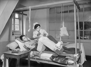Nurse using Carrel-Dakin Antiseptic Solution on wounded Leg of American Soldier