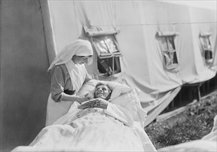 Nurse cheering up Injured American Soldier