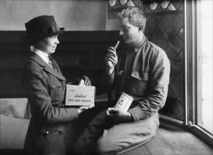 American Soldier receiving Chocolate from Female American Red Cross Worker