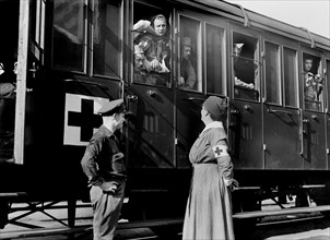 American Red Cross Nurse and Camion Driver welcoming Train-load of Wounded French Soldiers at Railroad Station