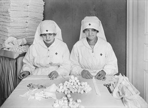 Two French Women employed by American Red Cross to mold Gauze Packing at American Red Cross Workrooms for Surgical Dressings