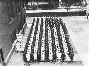Junior Red Cross Auxiliary forming American Flag
