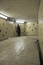 Young Adult Woman standing at end of Underground Pedestrian Tunnel