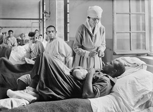 Injured American Soldier receiving Cigarette from American Red Cross Worker at Base Hospital 41