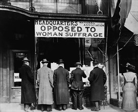 Men looking at Material posted in Window of National Association Opposed to Woman Suffrage Headquarters