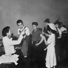 Evacuees of Japanese Descent being inoculated as they registered for Evacuation and Assignment to War Relocation Authority Centers for the duration of the War