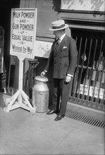 Singer John Barnes Wells with Milk Can and Sign promoting Committee for Free Milk for France which raised money to send powdered milk to France during World War I
