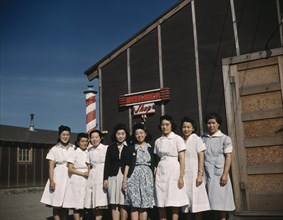 Eight Women standing in front of Camp Barber Shop