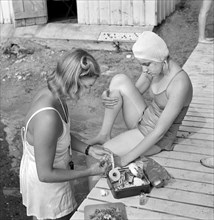 Girl applying First Aid to another Girl