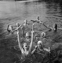 Group of Girls waiting to Catch Large Rubber Ball in Lake