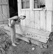 Girl putting Check on Checkboard to indicate she is in Swimming