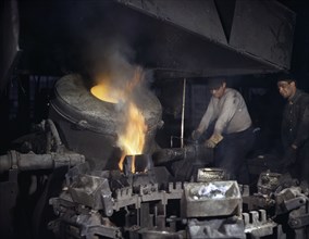 Worker Casting a Billet from an Electric Furnace