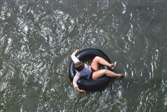 Young Woman floating in Inner Tube