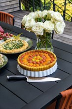 Tomato and Zucchini Tarts on Table in Outdoor Setting