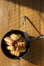 High Angle View of Apple Pastries with Fork in Cast Iron Skillet